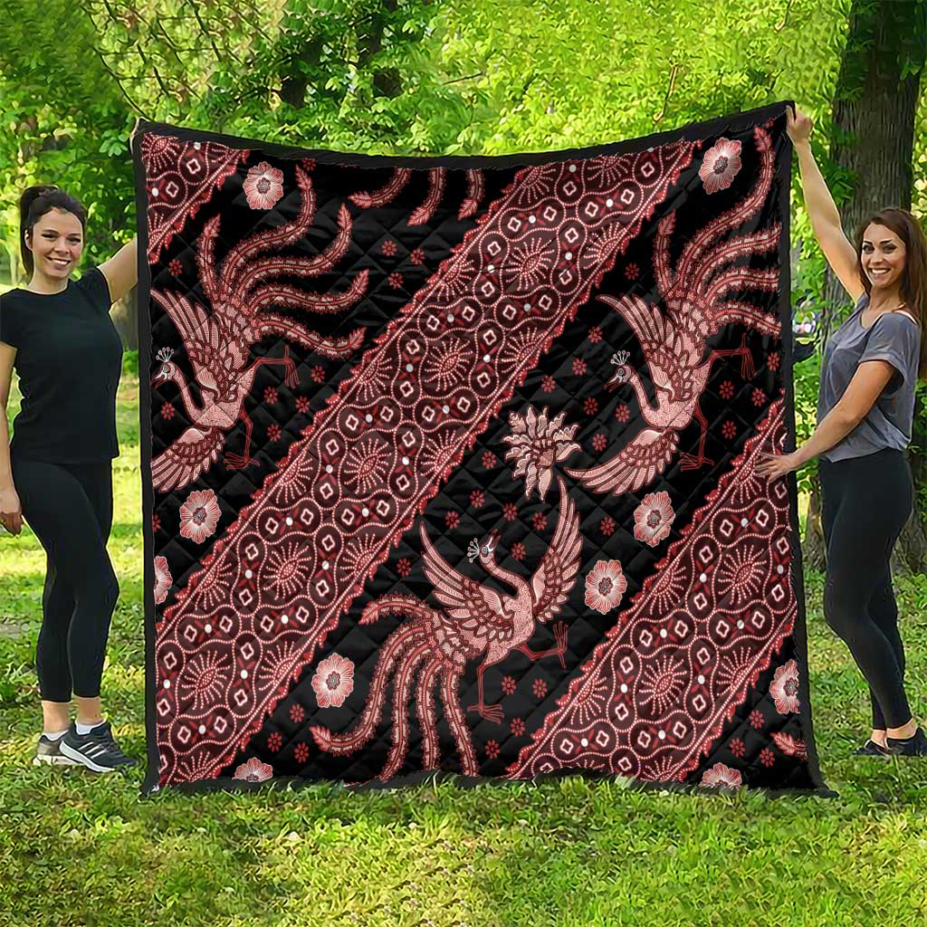 Red and black batik pattern quilt blanket with ornate floral and animal designs