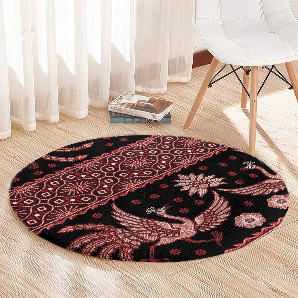 Circular batik rug, black base with red bird and flower design, decorative border