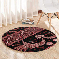 Circular batik rug, black base with red bird and flower design, decorative border