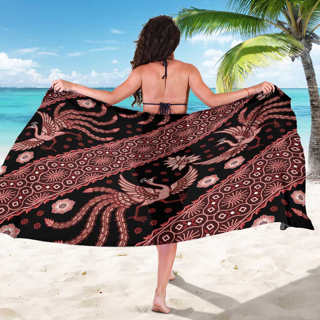 Black batik sarong with red and pink swirling motifs and elephant figures, open wrap