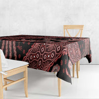 Red batik tablecloth draped over table edge, dark base with bird and floral batik motifs