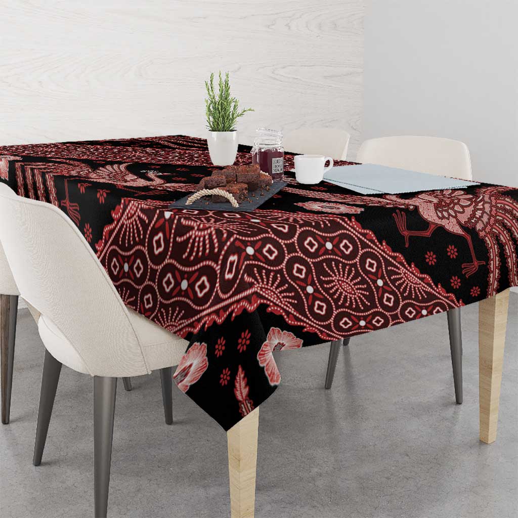 Red batik tablecloth on dining table, dark base with bird and floral batik motifs