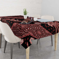 Red batik tablecloth on dining table, dark base with bird and floral batik motifs