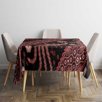 Red batik tablecloth covering table, dark base with batik birds, flowers, and geometric lines