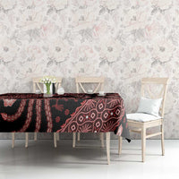 Red batik tablecloth on dining table, dark base with bird, floral, and geometric motifs