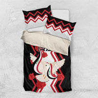 Black bedding set with central dove motif, red roses, and chevron pillow shams