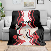 Black sofa blanket with red zigzags, white dove holding a flag, IRAQ logo in center.