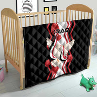 Black quilt draped over a crib, with “IRAQ” logo, red-and-white stripes, and dove motif