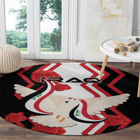 Round black carpet with dove carrying flag, red roses, and zigzag chevron center