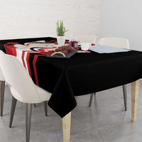 Black tablecloth with red and white flag-style border and dove motif