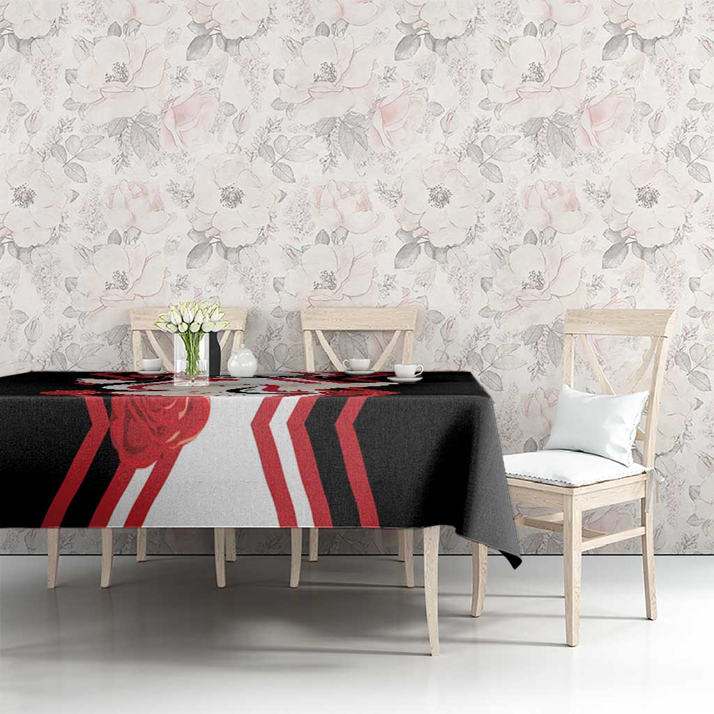Black tablecloth with red and white dove flag pattern across dining table