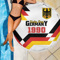 Round white fringed beach blanket showing Unity Day Germany 1990 logo and flag stripes