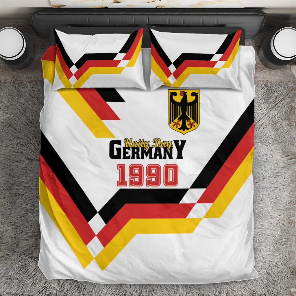 White bedding set with Unity Day 1990 print, shield logo, and multicolor chevron pattern