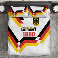 White bedding set with Unity Day 1990 print, shield logo, and multicolor chevron pattern