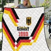 White quilt on chair with Germany 1990 text and red-yellow-black chevron V
