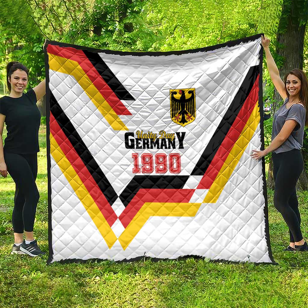 White quilt stretched outdoors with Germany 1990 emblem and red, yellow, black V stripes