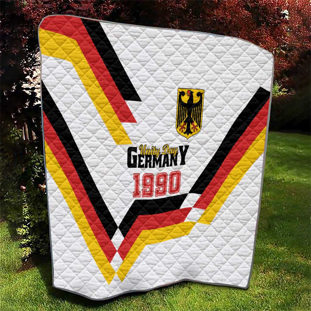 White quilt with red, yellow, black V design and Germany 1990 patch