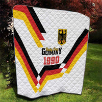 White quilt with red, yellow, black V design and Germany 1990 patch