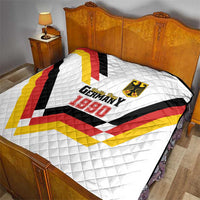 White quilt on bed with Germany 1990 logo and crest over quilted V pattern