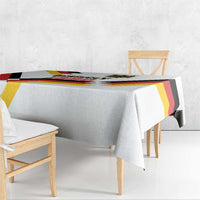 White tablecloth with Unity Day 1990 lettering and black red yellow geometric trim