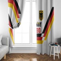 Two hanging white curtain panels with Germany Unity Day 1990 text and red yellow black stripes.