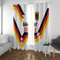 White window curtains showing Germany Unity Day 1990 logo, crest, and red yellow black zigzag stripes.