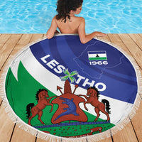 Round Lesotho flag beach blanket with fringe, coat-of-arms graphic centered in blue and green