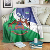 Lesotho-themed blanket with blue, white, and green flag design and coat of arms, draped
