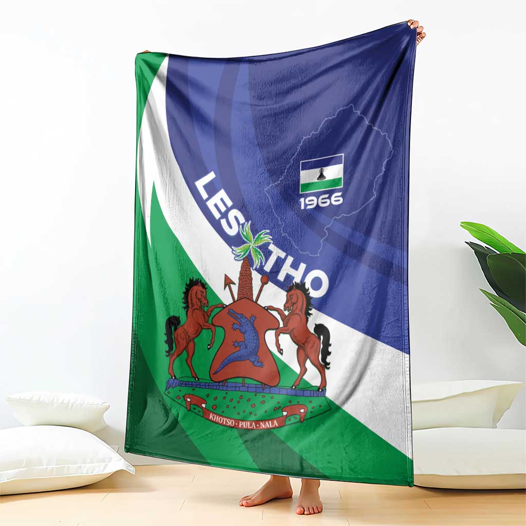 Lesotho-themed blanket with blue, white, and green flag stripes and coat of arms, folded