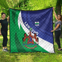 Large flag quilt spread on grass, green-white-blue diagonal stripes with coat-of-arms and 1966