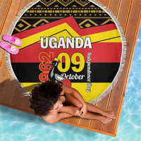 Round beach blanket with fringe, Uganda 09 October flag pattern in black, yellow, red.