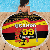 Round beach blanket with fringe, Uganda 09 October flag pattern with geometric black trim.