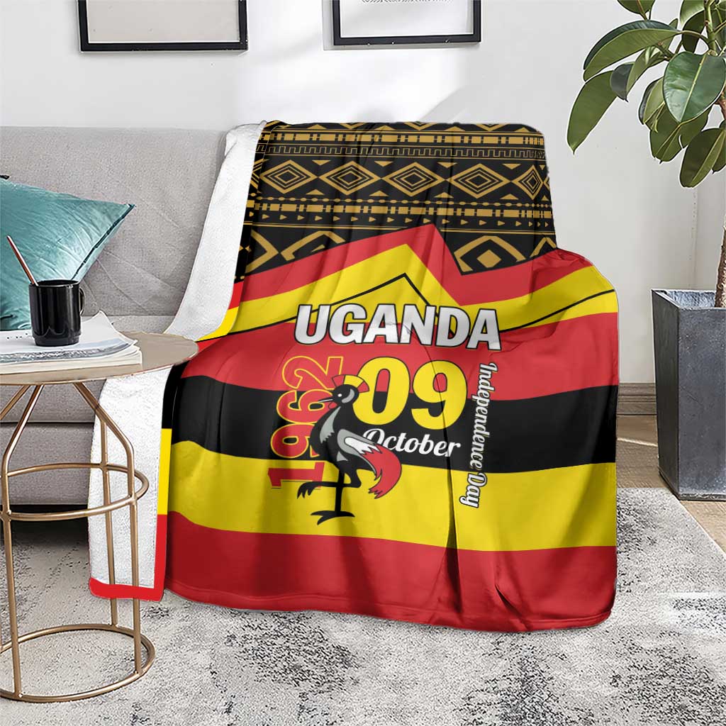 Uganda Independence Day blanket on floor with 'UGANDA' title and patterned border