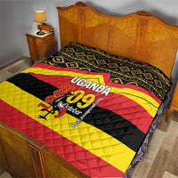 Uganda-themed quilt on bed with black, yellow, and red diagonal stripes and central “UGANDA 09 October”