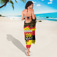 Black sarong with red and yellow stripes and 'UGANDA 09 October' on back
