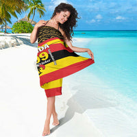 Black sarong scarf with red/yellow stripes and bold 'UGANDA 09' text