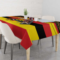 Printed Uganda-themed tablecloth in red, yellow, and black with bold stripe and emblem