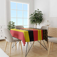 Printed tablecloth on dining set with red, yellow, and black Uganda flag-style pattern