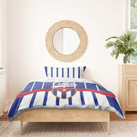 Blue and white striped bedding set with pillowcases featuring Cuba crest shield design