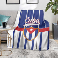 Cuba-themed blanket on sofa seat with blue-and-white stripes and red shield star emblem