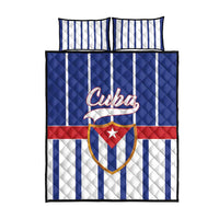 Blue quilt bed set with Cuba crest, vertical white stripes, and two matching pillowcases