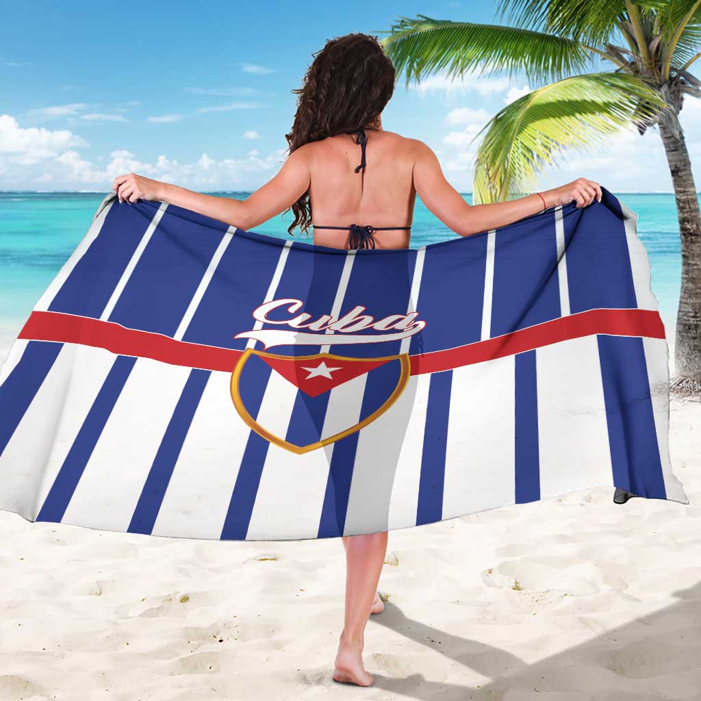 Blue and white striped sarong with red stripe and Cuba crest, worn as a wrap