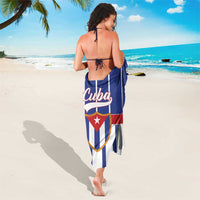 Blue sarong with white vertical stripes, red stripe, and Cuba shield crest on center