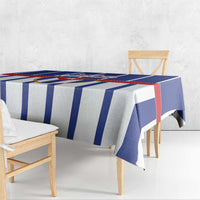 Blue, white, and red striped tablecloth with draped corners over seating