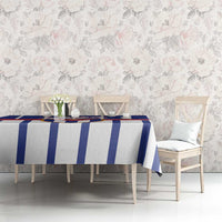 Blue and white striped tablecloth on a dining table with chairs