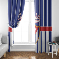 Blue curtain panels with vertical stripes and Cuba graphic near window
