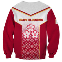 Red and gray sweatshirt with BRAVE BLOSSOMS text and blossom-and-wave panel
