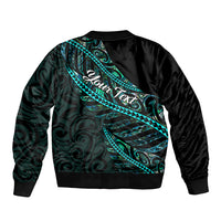 Black unisex bomber jacket with teal-green Polynesian back panel pattern, ribbed hem