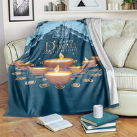 Blue Diwali festival blanket with candle and mandala artwork, draped over couch