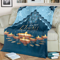 Blue Diwali festival blanket folded on couch with central mandala and diya candles